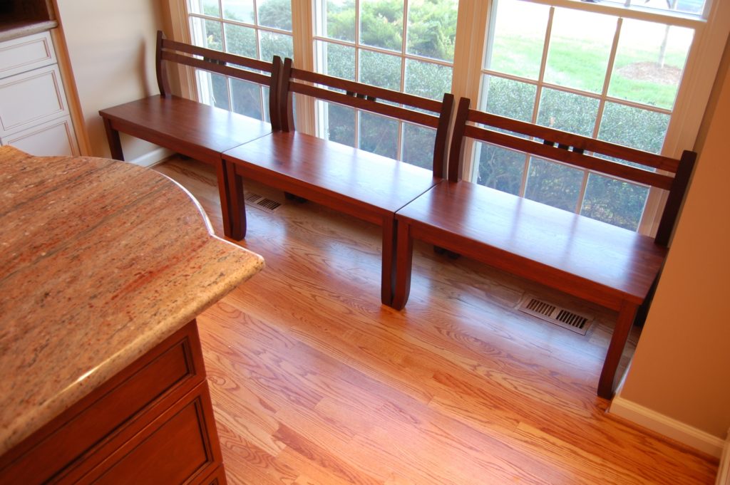 three demon benches in walnut side by side in kitchen
