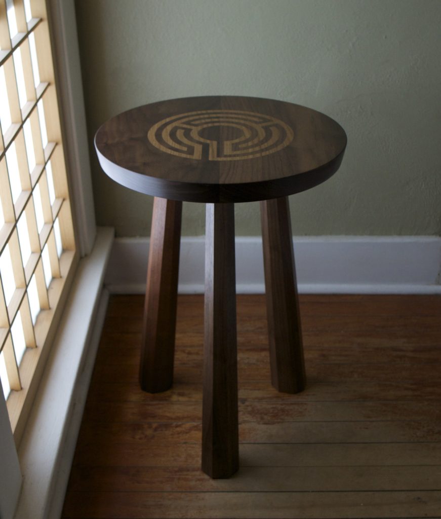 round tripod table in walnut with labyrinth inlay in the top